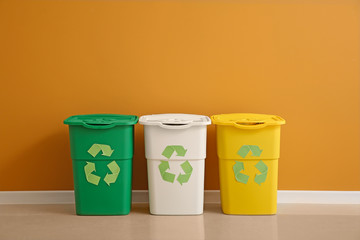 Containers for garbage near color wall. Recycling concept