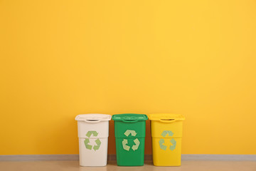 Containers for garbage near color wall. Recycling concept