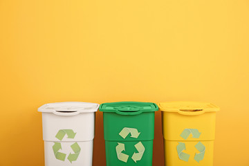 Containers for garbage near color wall. Recycling concept
