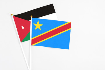 Congo and Jordan stick flags on white background. High quality fabric, miniature national flag. Peaceful global concept.White floor for copy space.