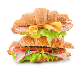 Tasty croissant sandwiches on white background