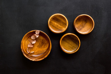 Making wooden dishes. Empty bowls on black background top view