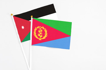 Eritrea and Jordan stick flags on white background. High quality fabric, miniature national flag. Peaceful global concept.White floor for copy space.