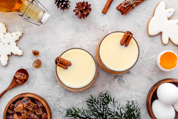 Make festive drink eggnog - ingredients on grey background top view