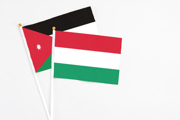 Hungary and Jordan stick flags on white background. High quality fabric, miniature national flag. Peaceful global concept.White floor for copy space.