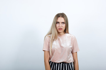 Young funny beautiful caucasian woman wearing nice pastel pink fashion shirt puffing cheeks with funny face. Mouth inflated with air, crazy expression.