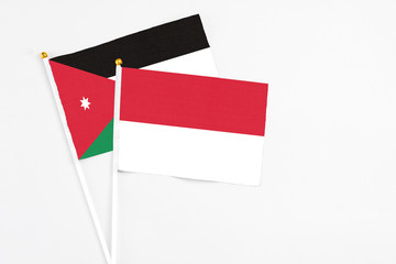 Indonesia and Jordan stick flags on white background. High quality fabric, miniature national flag. Peaceful global concept.White floor for copy space.