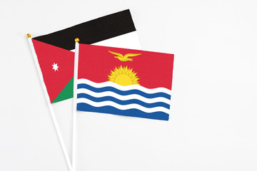 Kiribati and Jordan stick flags on white background. High quality fabric, miniature national flag. Peaceful global concept.White floor for copy space.
