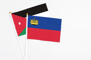 Liechtenstein and Jordan stick flags on white background. High quality fabric, miniature national flag. Peaceful global concept.White floor for copy space.