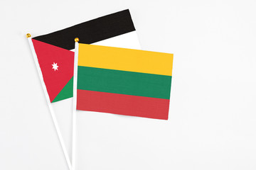 Lithuania and Jordan stick flags on white background. High quality fabric, miniature national flag. Peaceful global concept.White floor for copy space.
