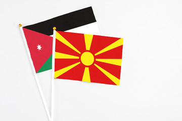Macedonia and Jordan stick flags on white background. High quality fabric, miniature national flag. Peaceful global concept.White floor for copy space.