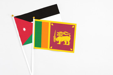 Sri Lanka and Jordan stick flags on white background. High quality fabric, miniature national flag. Peaceful global concept.White floor for copy space.