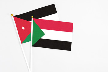 Sudan and Jordan stick flags on white background. High quality fabric, miniature national flag. Peaceful global concept.White floor for copy space.