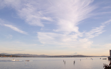 Mount Rainier overlooking Lake washinton and rowers in foreground with big milkyway sky