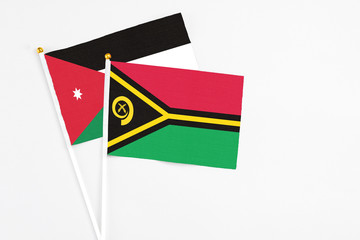 Vanuatu and Jordan stick flags on white background. High quality fabric, miniature national flag. Peaceful global concept.White floor for copy space.