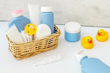 Baby bathroom cosmetics near pacifier and rubber duck on white background