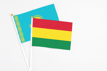 Bolivia and Kazakhstan stick flags on white background. High quality fabric, miniature national flag. Peaceful global concept.White floor for copy space.