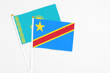 Congo and Kazakhstan stick flags on white background. High quality fabric, miniature national flag. Peaceful global concept.White floor for copy space.
