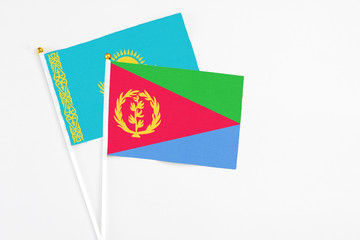 Eritrea and Kazakhstan stick flags on white background. High quality fabric, miniature national flag. Peaceful global concept.White floor for copy space.