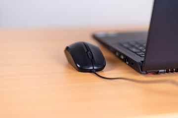 Obraz na płótnie Canvas Black wired computer mouse closeup toned.