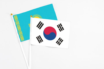 South Korea and Kazakhstan stick flags on white background. High quality fabric, miniature national flag. Peaceful global concept.White floor for copy space.