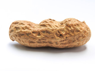 Top view of an raw unshelled peanuts also called groundnut isolated on white background. With...