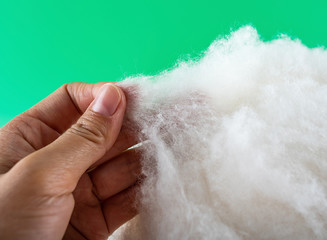 Obraz premium Tear-finished cotton material detail close-up on green background