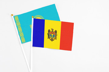 Moldova and Kazakhstan stick flags on white background. High quality fabric, miniature national flag. Peaceful global concept.White floor for copy space.