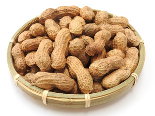 High angle view of a pile of raw peanuts also called groundnut on bamboo plate isolated on white background. Food concept.With edible seeds and high oil content.Oil crop. Common ingredients in Taiwan.