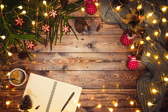 Merry Christmas and Happy New Year. Christmas composition. Gifts, fir tree branches, ball red decorations on a wooden background with copy space for your text. Christmas, winter new year concept. Led 