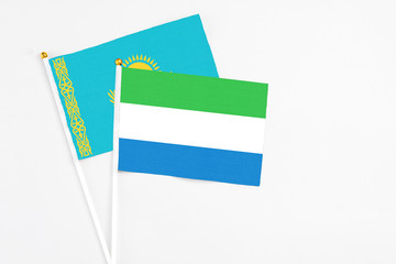 Sierra Leone and Kazakhstan stick flags on white background. High quality fabric, miniature...
