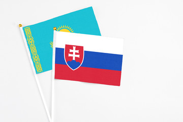 Slovakia and Kazakhstan stick flags on white background. High quality fabric, miniature national flag. Peaceful global concept.White floor for copy space.