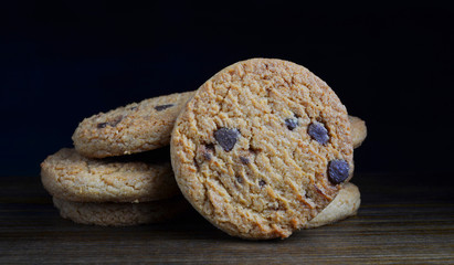 chocolate chip biscuits on black background
