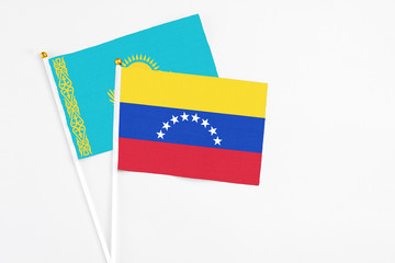 Venezuela and Kazakhstan stick flags on white background. High quality fabric, miniature national flag. Peaceful global concept.White floor for copy space.