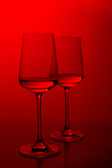Rose wine in the glass at white background, romantic and elegant wine photo with copy space