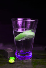 glass of water with lemon and ice on white background