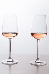 Rose wine in the glass at white background, romantic and elegant wine photo with copy space