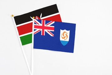 Anguilla and Kenya stick flags on white background. High quality fabric, miniature national flag. Peaceful global concept.White floor for copy space.