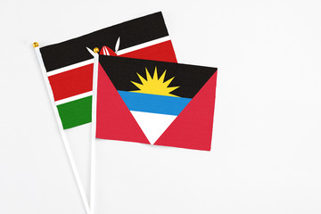 Antigua and Barbuda and Kenya stick flags on white background. High quality fabric, miniature national flag. Peaceful global concept.White floor for copy space.