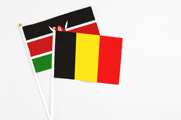 Belgium and Kenya stick flags on white background. High quality fabric, miniature national flag. Peaceful global concept.White floor for copy space.