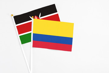 Colombia and Kenya stick flags on white background. High quality fabric, miniature national flag. Peaceful global concept.White floor for copy space.