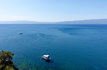 View of Ohrid Lake with pleasure boats to the Church of St. Kaneo in Ohrid