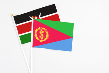 Eritrea and Kenya stick flags on white background. High quality fabric, miniature national flag. Peaceful global concept.White floor for copy space.