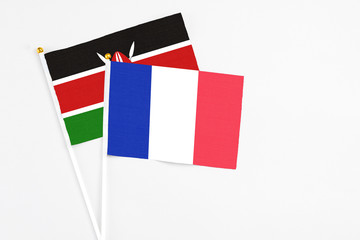 France and Kenya stick flags on white background. High quality fabric, miniature national flag. Peaceful global concept.White floor for copy space.