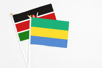 Gabon and Kenya stick flags on white background. High quality fabric, miniature national flag....
