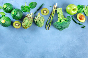 Green fruits and vegetables, detox diet food, top-down flat lay shot with copy space