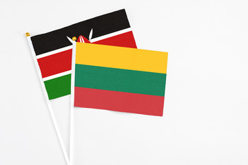 Lithuania and Kenya stick flags on white background. High quality fabric, miniature national flag. Peaceful global concept.White floor for copy space.