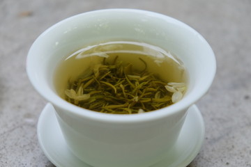 Close up tea water in traditional Chinese tea cup. Blur background
