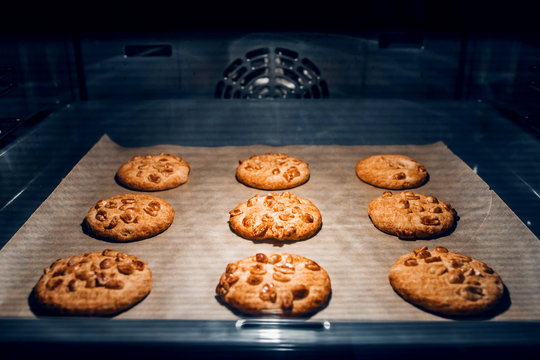 Round homemade cookies on a baking sheet in the oven