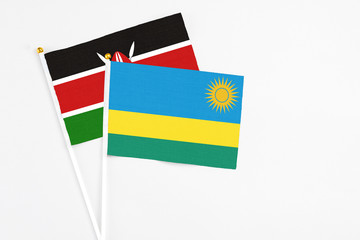 Rwanda and Kenya stick flags on white background. High quality fabric, miniature national flag. Peaceful global concept.White floor for copy space.